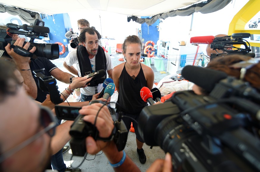 Carola Rackete, captain of rescue ship Sea-Watch 3, speaks to the media as the ship remains blocked one mile outside the port of Lampedusa, Italy, June 27, 2019. REUTERS/Guglielmo Mangiapane
