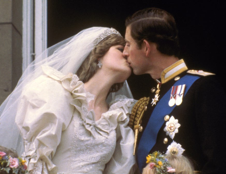 FILE - In this July 29, 1981 file photo, Britain&#039;s Prince Charles kisses his bride, the former Diana Spencer, on the balcony of Buckingham Palace in London, after their wedding. Britain’s royal f ...