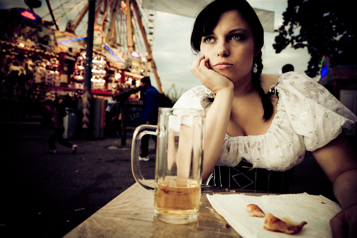young woman getting bored at the carnival