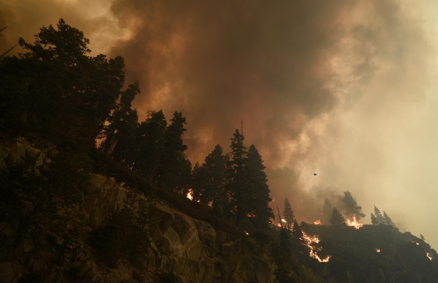 MEYER, CA, USA - AUGUST 30: Flames and smoke rise as the Caldor fire moves closer to South Lake Tahoe, California on August 30, 2021. Fire crews worked all day Monday to control spot fires and keep th ...