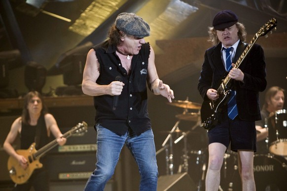 epa04168628 (FILE) The file picture dated 06 April 2009 shows British lead singer Brian Johnson (C), Scottish guitarist Malcom Young (L) and his brother Angus Young (Front-R) of Australian rock band A ...