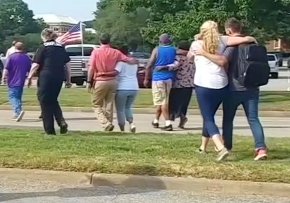 Evacuees walk away from a building in this still image taken from video following a shooting incident at the municipal center in Virginia Beach, Virginia, U.S. May 31, 2019. WAVY-TV/NBC/via REUTERS AT ...