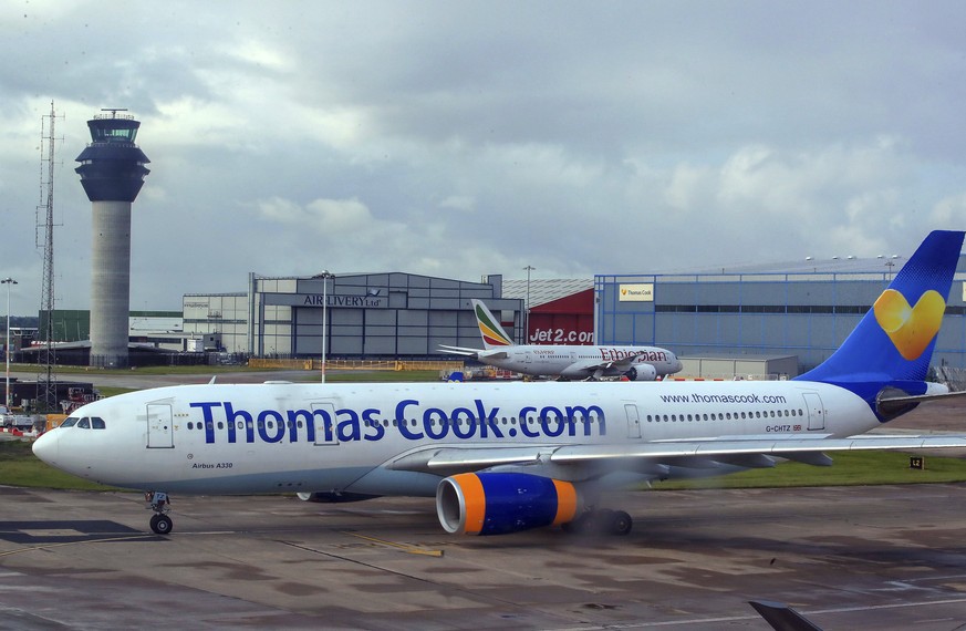 FILE - In this Aug. 13, 2019 file photo a Thomas Cook plane taxis on the runway at terminal one of Manchester Airport, England. More than 600,000 vacationers who booked through tour operator Thomas Co ...