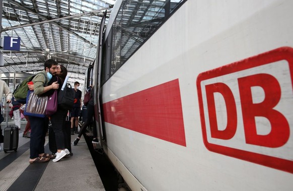 BERLIN, GERMANY - AUGUST 10: Passengers embrace as people prepare to board an Intercity Express (ICE) train at Berlin&#039;s main train station, or Hauptbahnhof, on August 10, 2021 in Berlin, Germany. ...