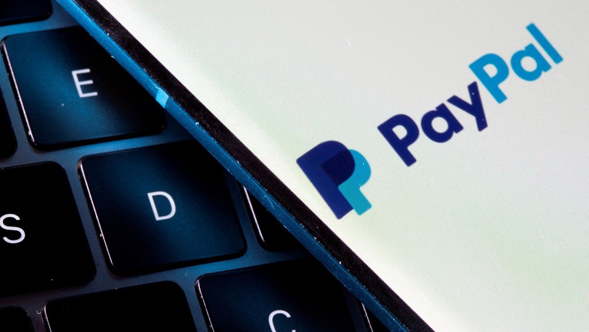 FILE PHOTO: A smartphone with the PayPal logo is placed on a laptop in this illustration taken on July 14, 2021. REUTERS/Dado Ruvic/File Photo