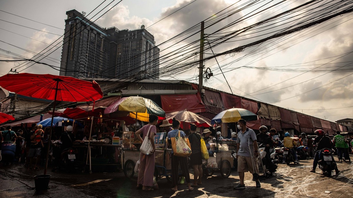 April 28, 2024, Bangkok, Thailand: People move around a market under the scorching sun during a period or severe heat warnings from the Thai meteorological department in Bangkok, Thailand, on Sunday,  ...