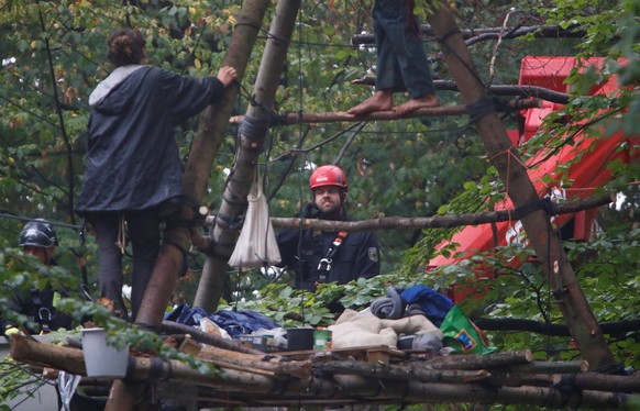 Activists are seen at the treehouse, as policemen try to clear the area at the &quot;Hambacher Forst&quot; in Kerpen-Buir near Cologne, Germany, September 13, 2018, where protesters have built a camp  ...