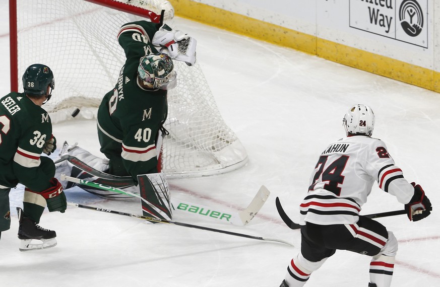 Chicago Blackhawks' Dominik Kahun, right, of the Czech Republic, scores a goal against Minnesota Wild goalie Devan Dubnyk during the first period of an NHL hockey game Thursday, Oct. 11, 2018, in St.  ...