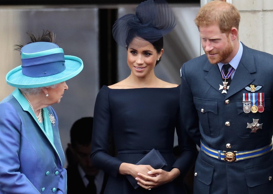 LONDON, ENGLAND - JULY 10: (L-R) Queen Elizabeth II, Meghan, Duchess of Sussex, Prince Harry, Duke of Sussex watch the RAF flypast on the balcony of Buckingham Palace, as members of the Royal Family a ...