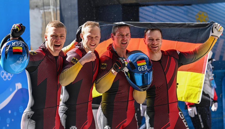 220220 -- BEIJING, Feb. 20, 2022 -- Francesco Friedrich/Thorsten Margis/Candy Bauer/Alexander Schueller of Germany celebrate winning after the bobsleigh 4-man heat of Beijing 2022 Winter Olympics at N ...