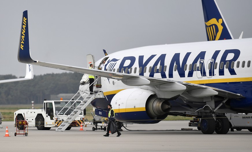 FILE - A Ryanair plane parks at the airport in Weeze, Germany, Sept. 12, 2018. Budget airline Ryanair says it's forcing South African travellers to the U.K. to do a test in the Afrikaans language to p ...