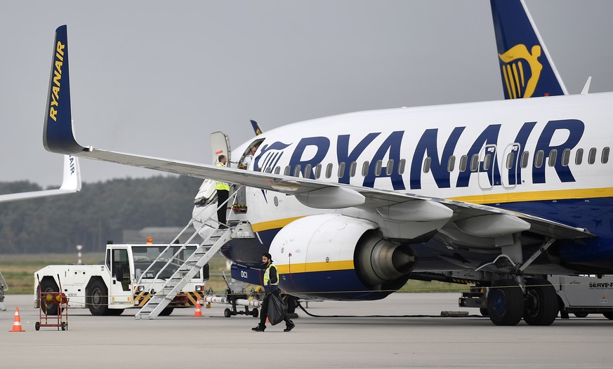 FILE - A Ryanair plane parks at the airport in Weeze, Germany, Sept. 12, 2018. Budget airline Ryanair says it&#039;s forcing South African travellers to the U.K. to do a test in the Afrikaans language ...