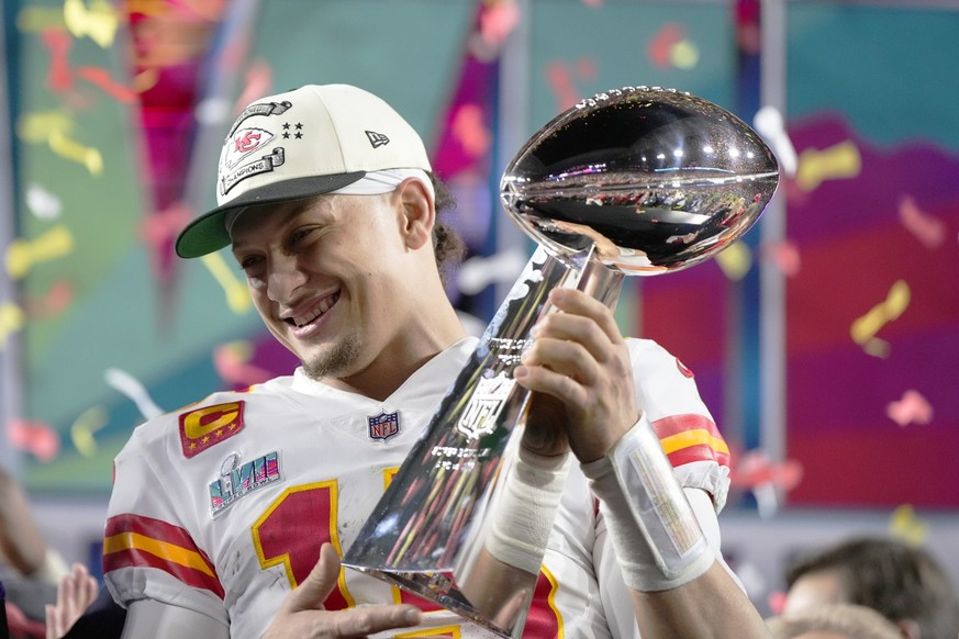 Kansas City Chiefs quarterback Patrick Mahomes (15) holds the trophy after their win against the Philadelphia Eagles in the NFL Super Bowl 57 football game, Sunday, Feb. 12, 2023, in Glendale, Ariz. T ...