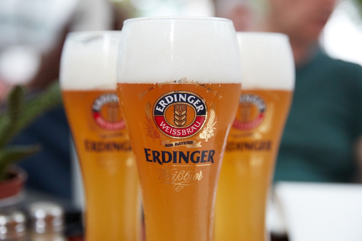 Dusseldorf, Germany 06,06,2016 : Glowing weiss glass of light Erdinger Beer on a pub. bokeh background, Dusseldorf, Germany 06,06,2016 : Glowing weiss glass of light Erdinger Beer on a pub. bokeh back ...