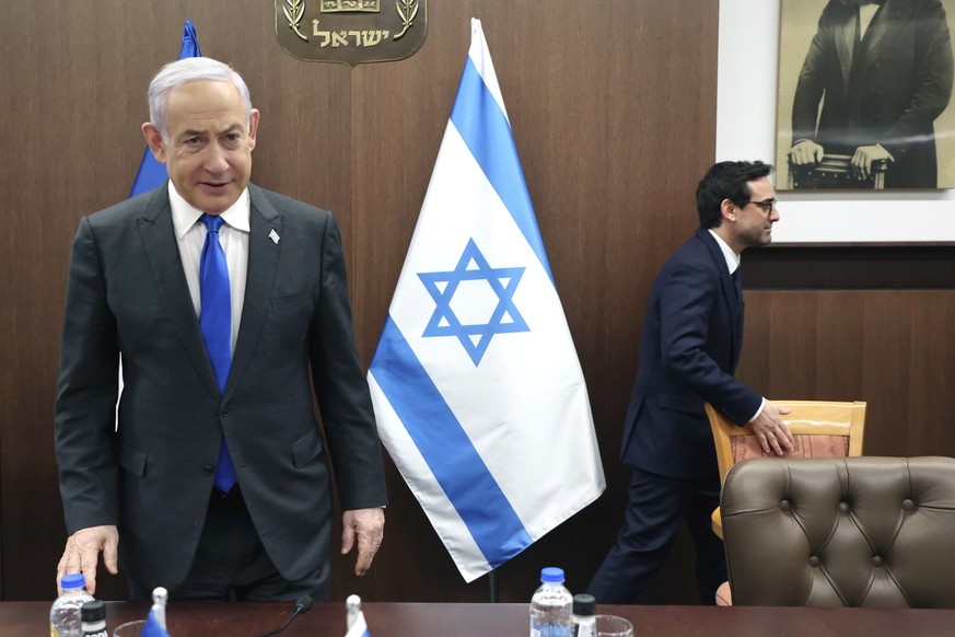 Israeli Prime Minister Benjamin Netanyahu, left, takes a seat before his meeting with France&#039;s Foreign Minister Stephane Sejourne, right, in Jerusalem Monday, Feb. 5, 2024. 5, 2024. (Gil Cohen-Ma ...