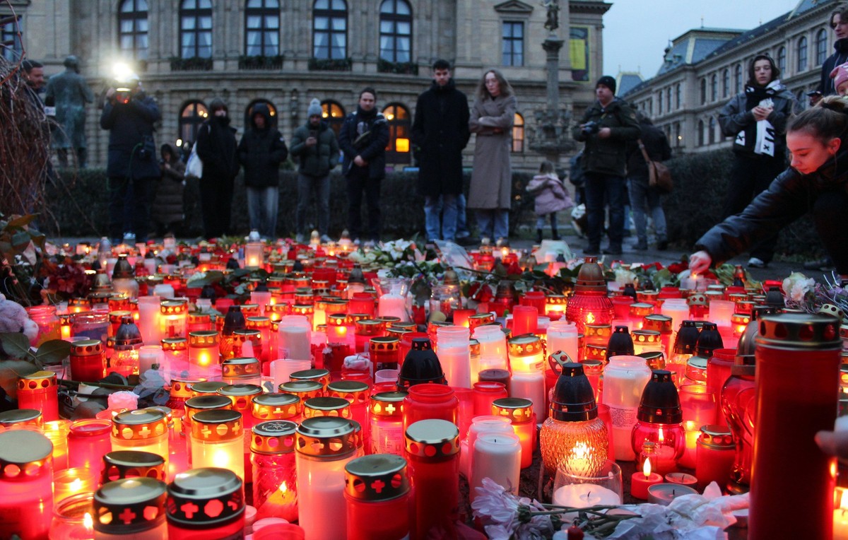 A woman lights a candle on Jan Palach Square near the Faculty of Arts, Charles University, in Prague, Czech Republic, on December 22, 2023. Twenty-four-year-old student shot dead 14 people and wounded ...