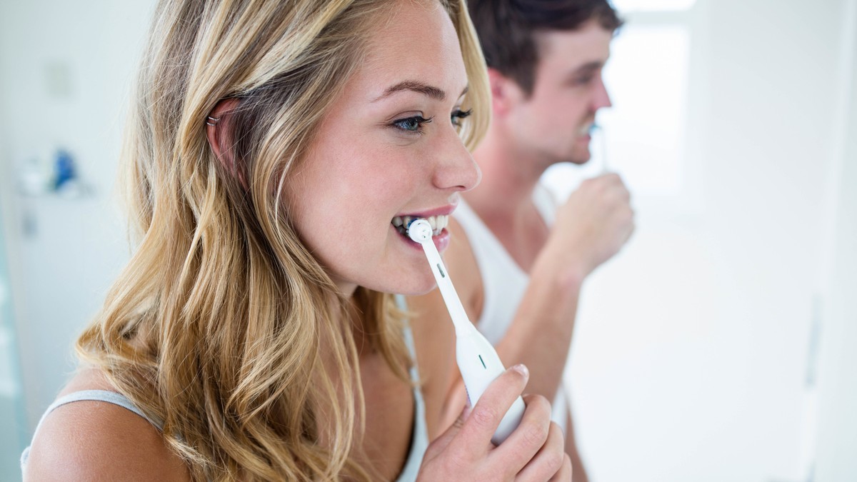 Young couple brushing their teeth at home in the bathroom