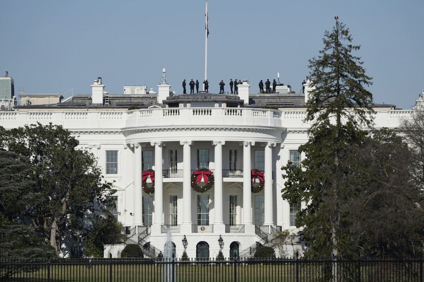 Security standing on the roof of the White House in preparation of the White House arrival of Ukrainian President Volodymyr Zelenskyy, Wednesday, Dec. 21, 2022 in Washington. Zelenskyy has arrived in  ...