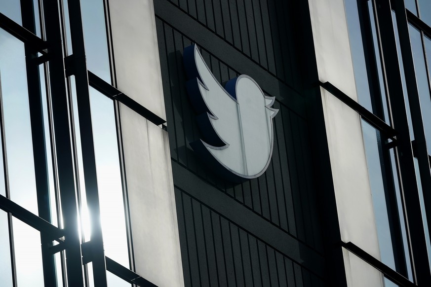 FILE - A Twitter logo hangs outside the company&#039;s offices in San Francisco, on Dec. 19, 2022. William Shatner, Monica Lewinsky and other prolific Twitter commentators — some household names, othe ...