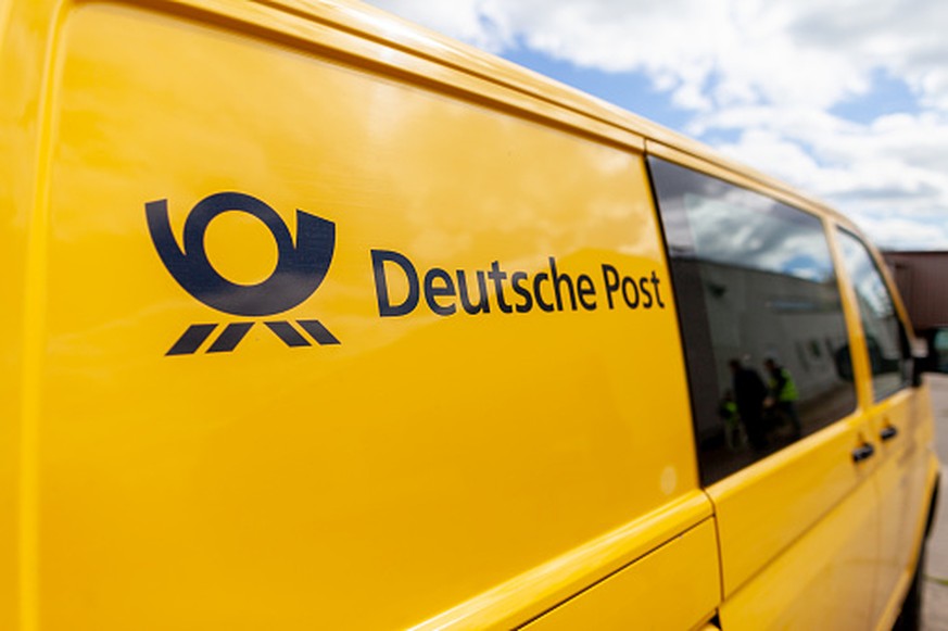Altentreptow / Germany May 1, 2018: Transport vehicle Volkswagen T5 from Deutsche Post ( german post ) stands on a street.