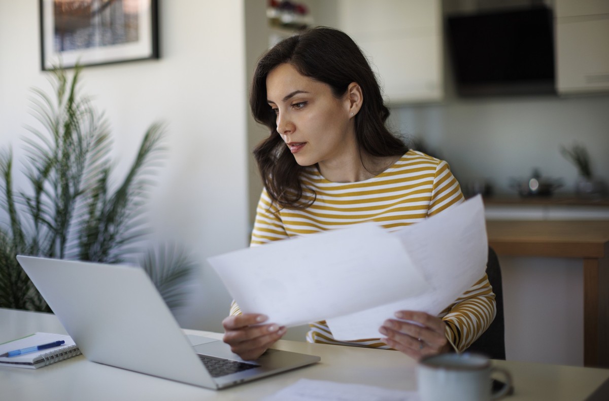 Young woman going throught her finances at home