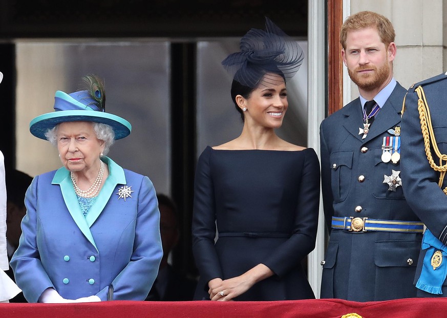 LONDON, ENGLAND - JULY 10: Queen Elizabeth II, Prince Harry, Duke of Sussex and Meghan, Duchess of Sussex on the balcony of Buckingham Palace as the Royal family attend events to mark the Centenary of ...