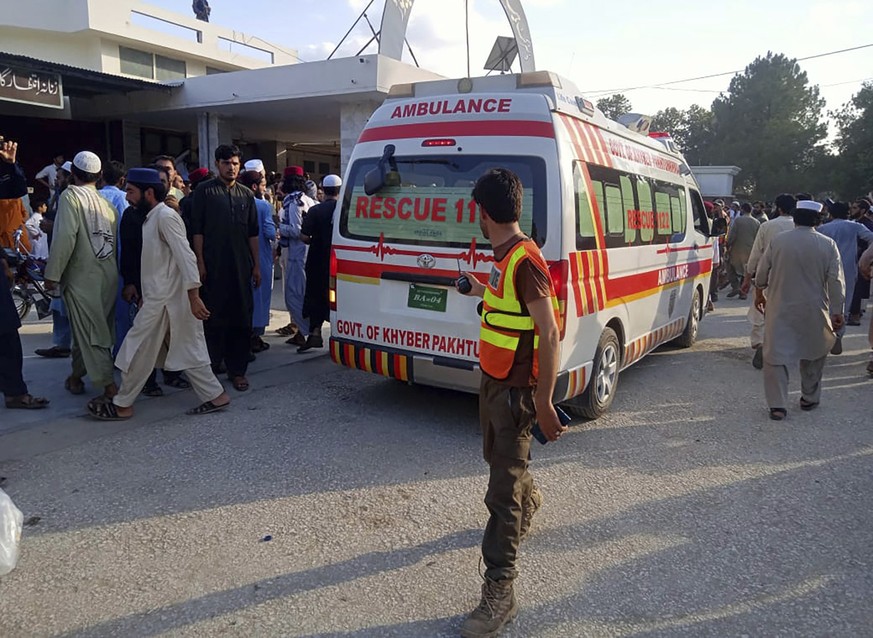 In this photo provided by Rescue 1122 Head Quarters, an ambulance carries injured people after a bomb explosion in the Bajur district of Khyber Pakhtunkhwa, Pakistan, Sunday, July 30, 2023. A powerful ...