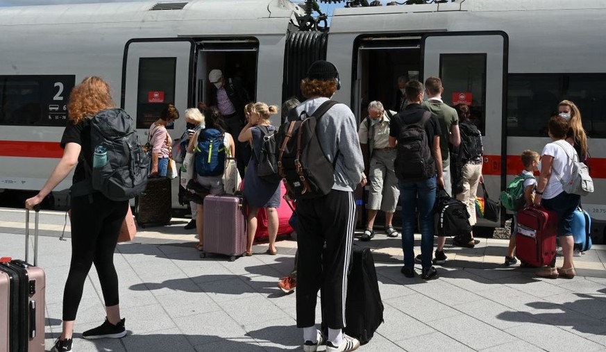Passangers wait next to a high speed ICE train of Germany&#039;s railway Deutsche Bahn at the central train station in Leipzig, eastern Germany, on August 16, 2021. (Photo by Christof STACHE / AFP) (P ...