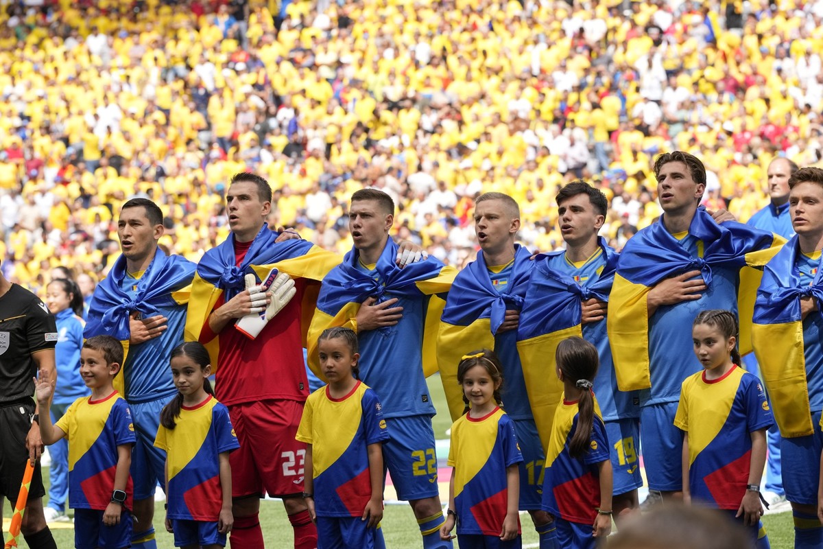 Ukrainian players sing their national anthem prior to a Group E match between Romania and Ukraine at the Euro 2024 soccer tournament in Munich, Germany, Monday, June 17, 2024. (AP Photo/Antonio Calann ...
