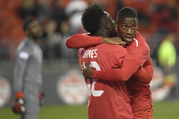 THE CANADIAN PRESS 2018-10-16. Canada&#039;s Jonathan David, right, celebrates his goal against Dominica with teammate Alphonso Davies during first half Concacaf Nations League qualifier soccer action ...
