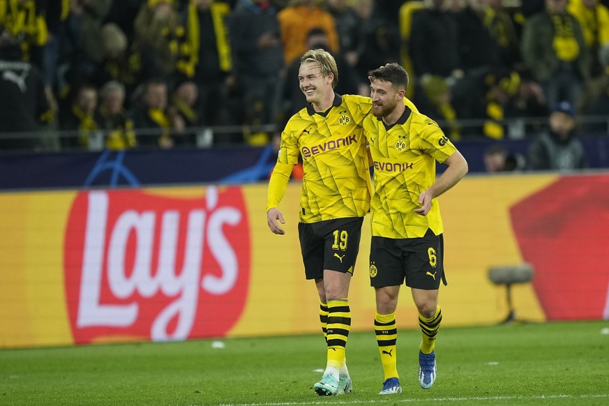Dortmund&#039;s Julian Brandt, left, celebrates with his teammate Salih Ozcan after scoring against Newcastle during the Champions League Group F soccer match between Borussia Dortmund and Newcastle U ...