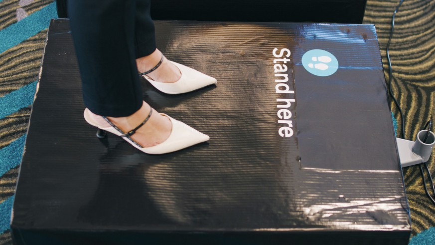 In this photo supplied by Air New Zealand, a woman stands on scales to be weighed ahead of a flight in Auckland, New Zealand on May 29, 2023. New Zealand&#039;s national airline is asking people to st ...