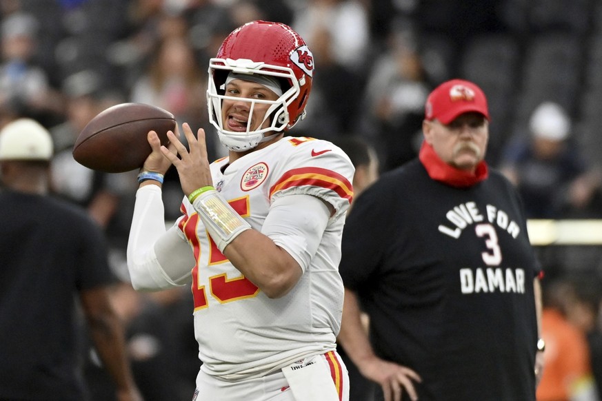 Kansas City Chiefs head coach Andy Reid, right, wears a shirt paying tribute to Buffalo Bills safety Damar Hamlin as he watches Chiefs quarterback Patrick Mahomes warm up before the start of an NFL fo ...