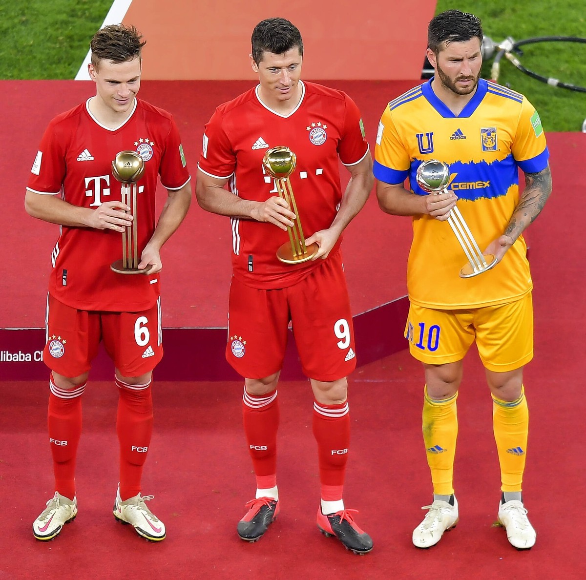 210212 -- DOHA, Feb. 12, 2021 -- Bayern Munich s Robert Lewandowski C, Tigres Uanl s Andre-Pierre Gignac R and Bayern Munich s Joshua Kimmich pose with their golden, silver and bronze balls awards aft ...