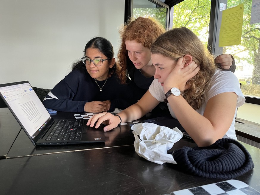 Patsy Islam-Parsons (v.l.), Jördis Thümmler und Annika Rittmann gehen gemeinsam eine FFF-Pressemitteilung durch.