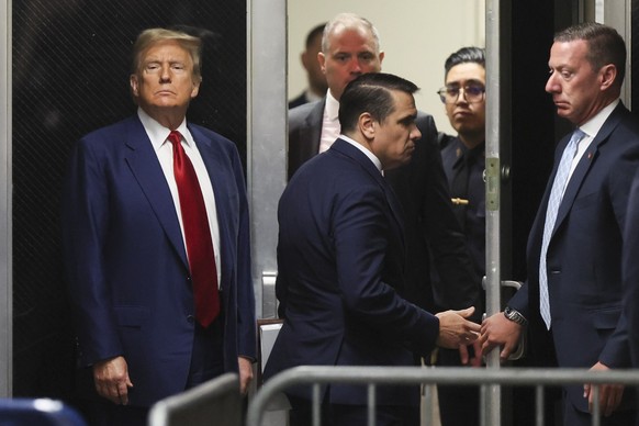 Former President Donald Trump stands in a hallway outside a courtroom where he is attending a hearing at New York Criminal Court, Monday, March 25, 2024, in New York. 2024. (Brendan McDermid/Pool Phot ...