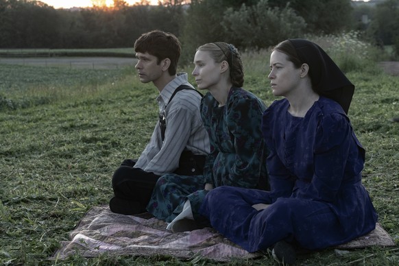 This image released by United Artists shows Ben Whishaw, from left, Rooney Mara and Claire Foy in a scene from &quot;Women Talking.&quot; (Michael Gibson/Orion - United Artists Releasing via AP)