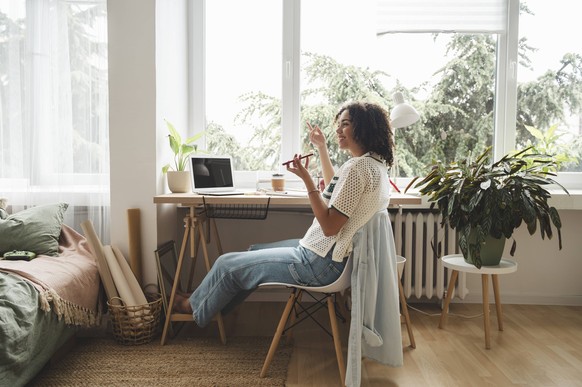 Happy teenage girl talking on mobile phone at desk model released, Symbolfoto property released, ALKF00693