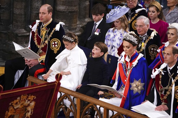 From left, 1st row, Britain&#039;s Prince William, Princess Charlotte, Prince Louis, Kate, Princess of Wales and Prince Edward, Duke of Edinburgh, at the coronation ceremony of King Charles III in Wes ...