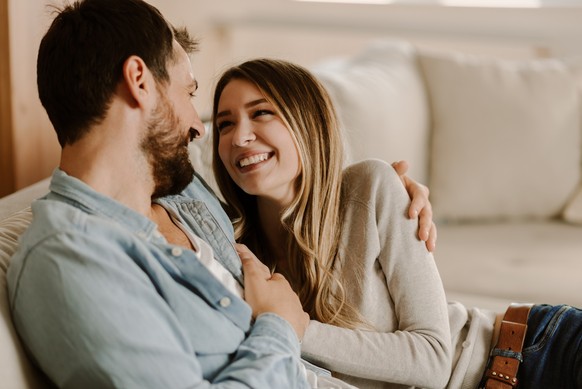 Loving happy couple talking to each other at home