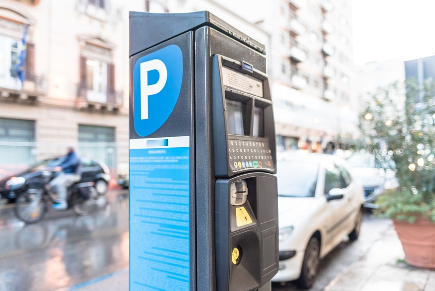 Parking meter on a city street operated with cash and credit cards.