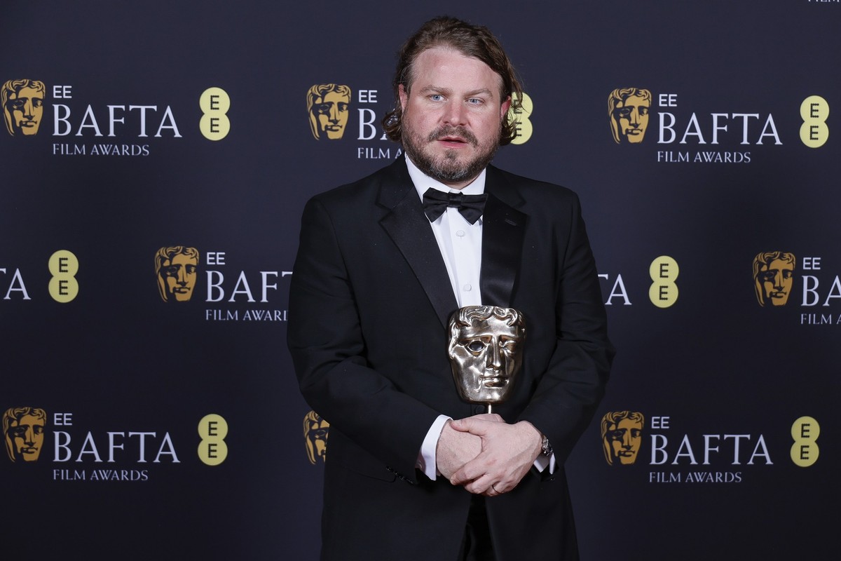 Brady Corbet poses with the award for best director for &quot;The Brutalist&quot; at the 78th British Academy Film Awards, BAFTA&#039;s, in London, Sunday, Feb. 16, 2025. (Photo by Joel C Ryan/Invisio ...
