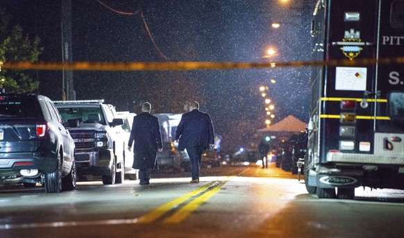 The FBI investigates in the rain after an active shooter situation at the Tree of Life Congregation on Saturday, Oct. 27, 2018, in the Squirrel Hill section of Pittsburgh. A gunman opened fire at the  ...