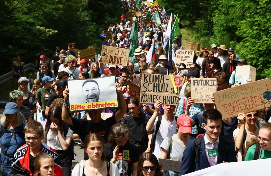 GROSSRASCHEN, GERMANY - JUNE 25: Climate activists protest at the Welzow Sued open-cast coal mine on June 25, 2023 near Grossraeschen, Germany. Activists from a variety of climate action groups, inclu ...