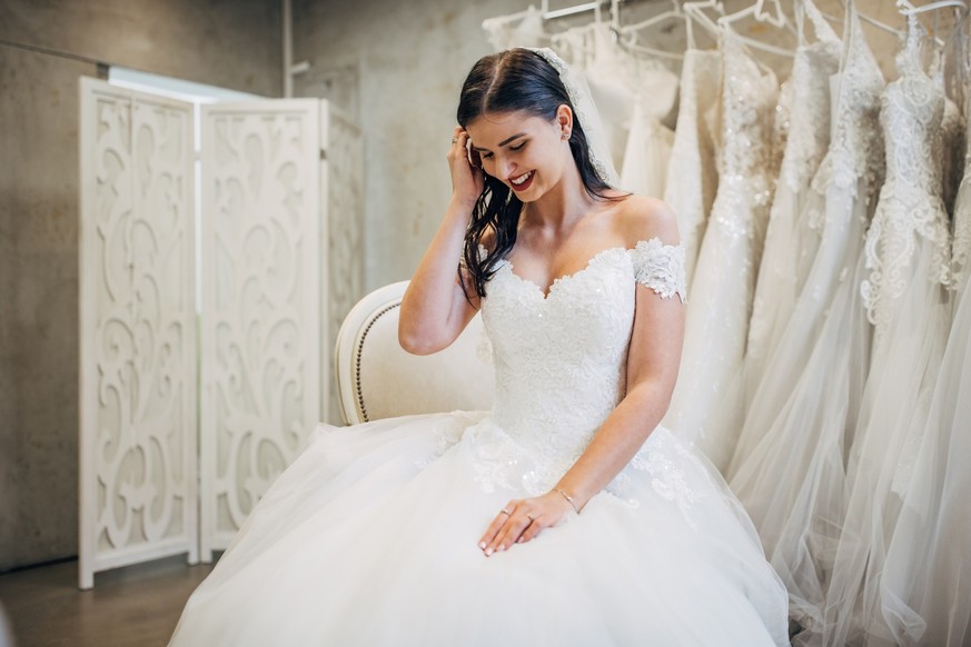 Bride trying out wedding dressing the bridal shop