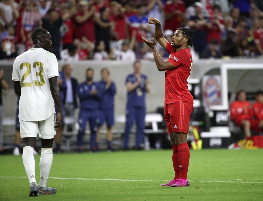 Jul 20, 2019; Houston, TX, USA; Bayern Munich midfielder Serge Gnabry (22) celebrates after scoring a goal as Real Madrid defender Ferland Mendy (23) looks on during the second half of the Internation ...