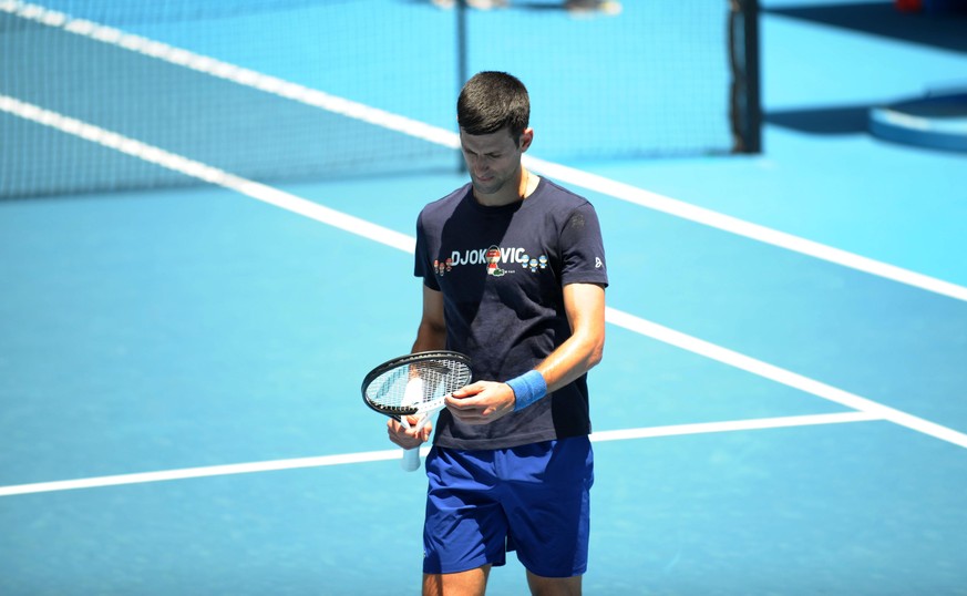 MELBOURNE, AUSTRALIA - JANUARY 12: Serbian tennis player Novak Djokovic trains in front of the press for the first time after his Australian visa was revoked at Rod Laver Arena in Melbourne, Australia ...
