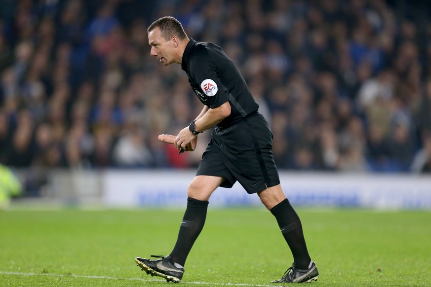 Brighton and Hove Albion v West Ham United - Premier League - AMEX Stadium EDITORS NOTE: EXPLICIT CONTENT Referee Kevin Friend picks up a dildo that was thrown on to the pitch during the match EDITORI ...
