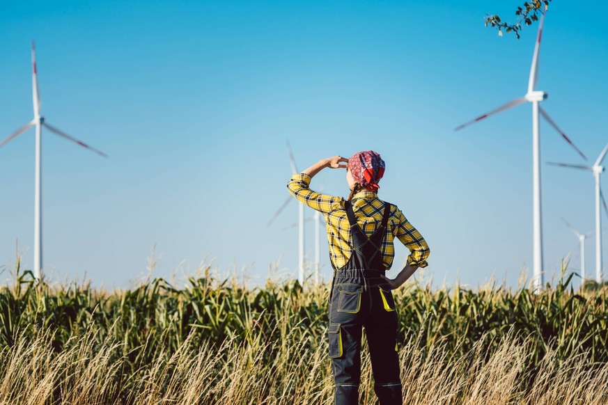 RECORD DATE NOT STATED Farmer woman has invested not only in land but also wind energy watching the turbines, model released, , 36267212.jpg, turbine, farmer, Woman, agriculture, Wind power, wind ener ...