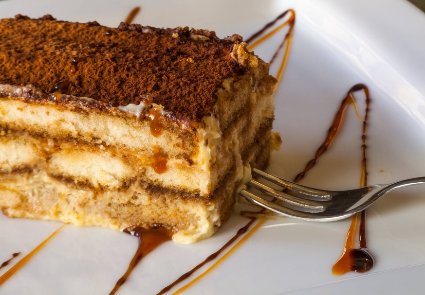 a huge chunk of the traditional Italian, unforgettably delicious, rich and sweet tiramisu cake with cinnamon, caramel, honey and dessert fork , 24142182.jpg, tiramisu, cake, food, dessert, sweet, brow ...